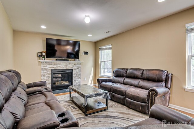 169 Metuchen Ave, Woodbridge Proper, NJ 07095 - living room with plenty of natural light, a stone fireplace, recessed lighting, and wood finished floors