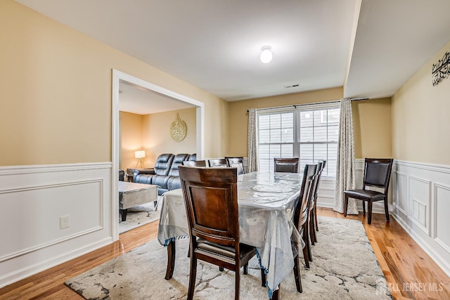 169 Metuchen Ave, Woodbridge Proper, NJ 07095 - dining space with a wainscoted wall, light wood-type flooring, and a decorative wall