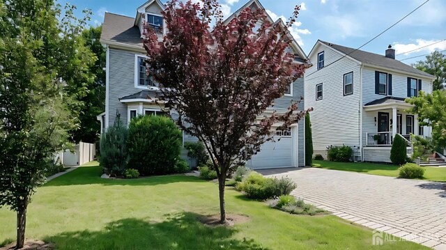 169 Metuchen Ave, Woodbridge Proper, NJ 07095 - view of front of house featuring driveway, a front lawn, and an attached garage