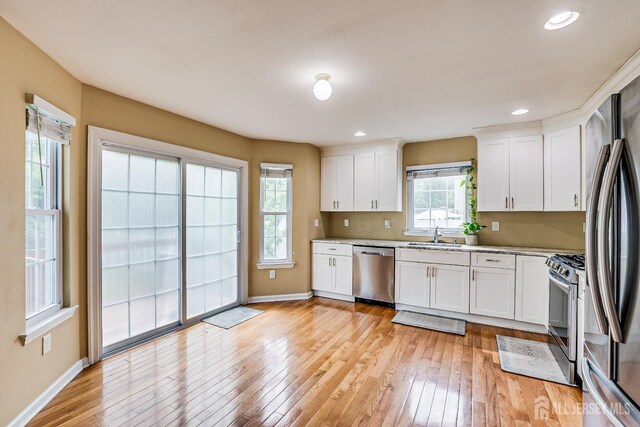 169 Metuchen Ave, Woodbridge Proper, NJ 07095 - kitchen with appliances with stainless steel finishes, light wood-type flooring, white cabinetry, light countertops, and recessed lighting