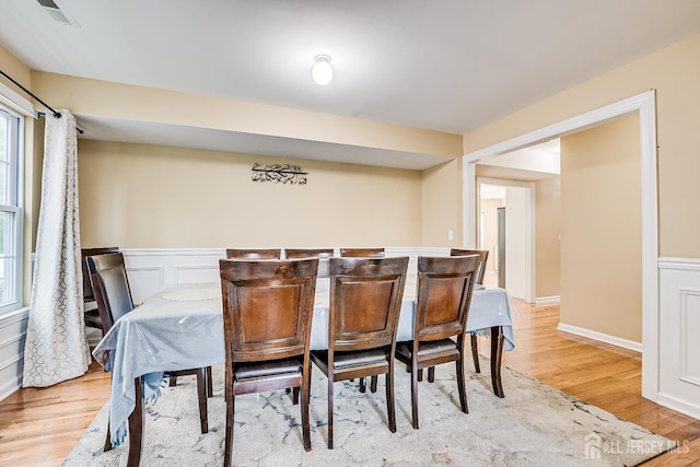 169 Metuchen Ave, Woodbridge Proper, NJ 07095 - dining room featuring light wood-style flooring and a wainscoted wall