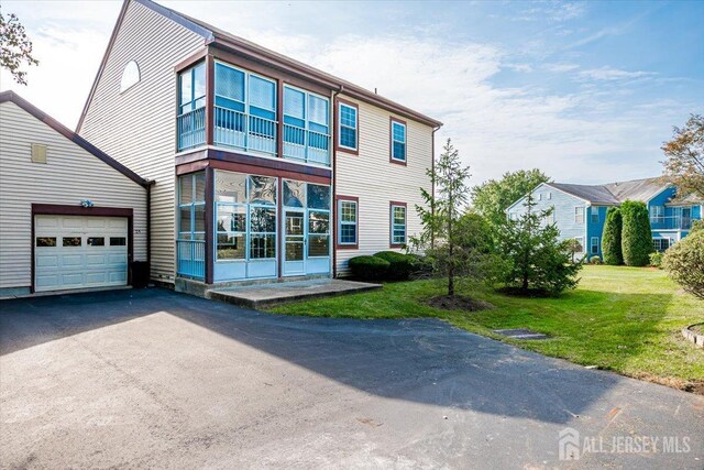 view of front of house featuring a garage and a front lawn