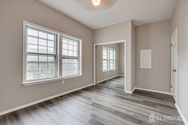 empty room featuring hardwood / wood-style floors and ceiling fan