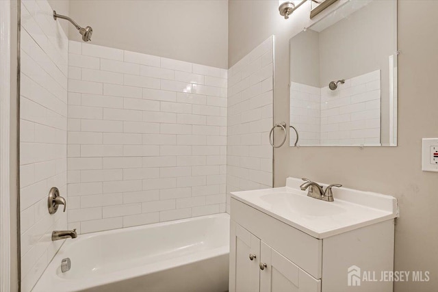 bathroom featuring vanity and tiled shower / bath combo