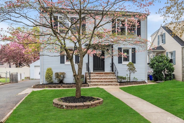 view of front of house featuring a garage and a front lawn