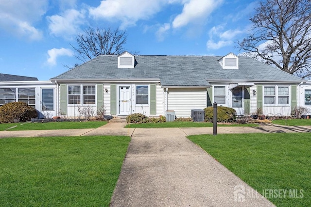 new england style home featuring a tile roof and a front lawn