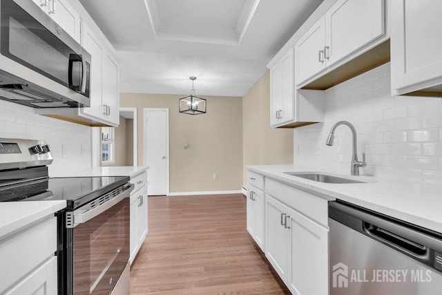 162 Providence Way, Monroe, NJ 08831 - kitchen with light countertops, a sink, light wood-style floors, decorative backsplash, and appliances with stainless steel finishes