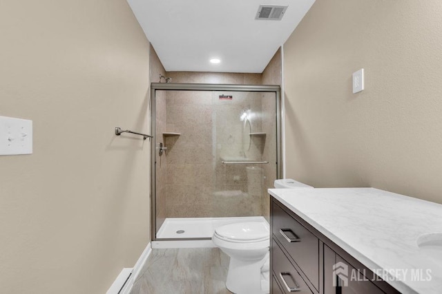 full bathroom featuring a stall shower, visible vents, vanity, and toilet