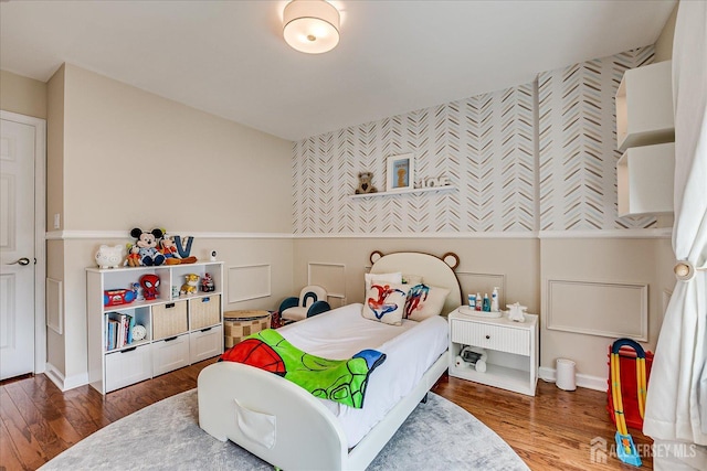 1142 Warren St, Roselle, NJ 07203 - bedroom featuring wallpapered walls, an accent wall, and wood finished floors