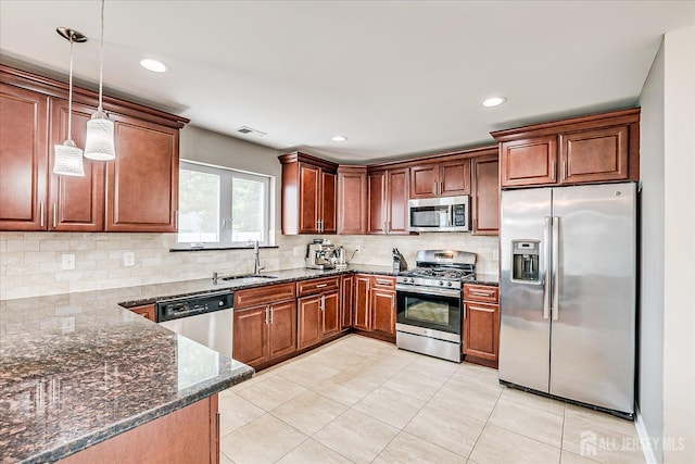 1142 Warren St, Roselle, NJ 07203 - kitchen with appliances with stainless steel finishes, dark stone counters, tasteful backsplash, hanging light fixtures, and recessed lighting
