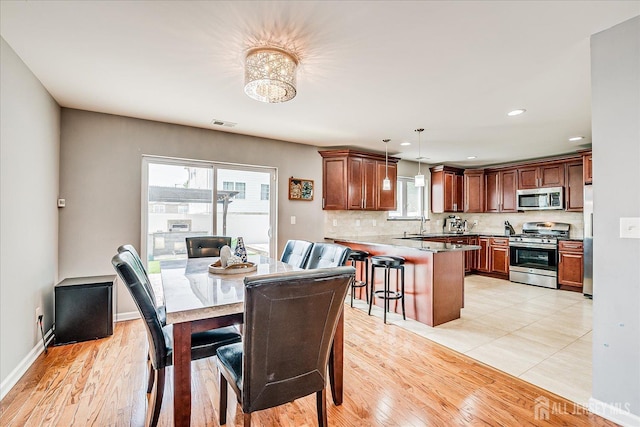1142 Warren St, Roselle, NJ 07203 - dining area with plenty of natural light, a chandelier, light wood-type flooring, and recessed lighting