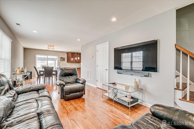 1142 Warren St, Roselle, NJ 07203 - living area featuring light wood finished floors, stairs, and recessed lighting