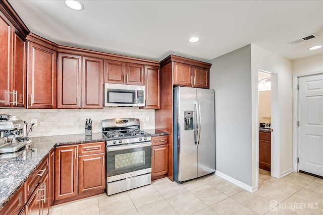 1142 Warren St, Roselle, NJ 07203 - kitchen featuring stainless steel appliances, tasteful backsplash, light tile patterned flooring, dark stone counters, and recessed lighting