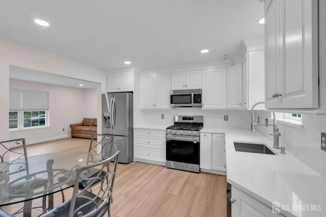 3 Malibu Ct, Jackson, NJ 08527 - kitchen with appliances with stainless steel finishes, white cabinets, light wood-style floors, and recessed lighting