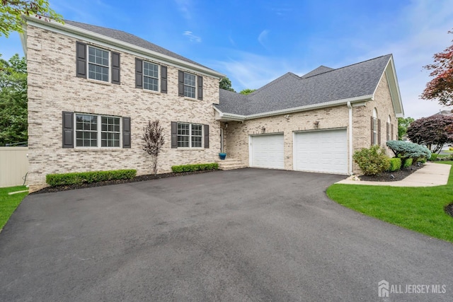 3 Malibu Ct, Jackson, NJ 08527 - colonial-style house featuring asphalt driveway, a garage, brick siding, and roof with shingles