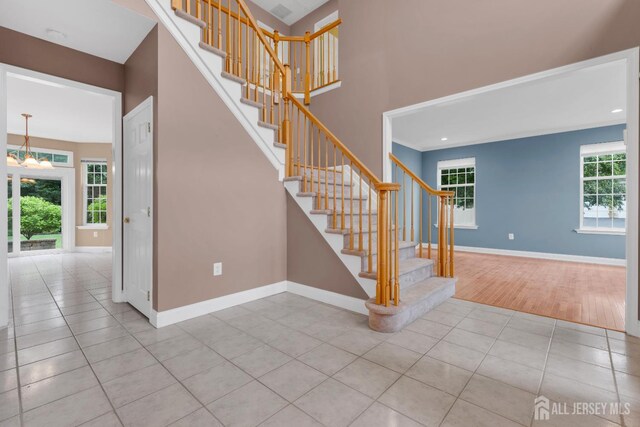 3 Malibu Ct, Jackson, NJ 08527 - stairs with tile patterned flooring and a chandelier