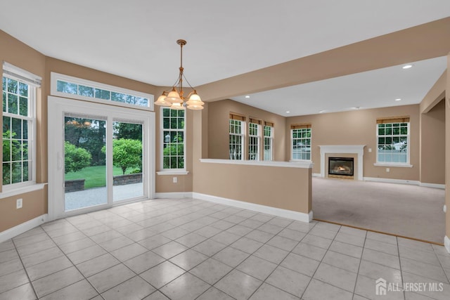 3 Malibu Ct, Jackson, NJ 08527 - unfurnished living room featuring a chandelier, light tile patterned flooring, a glass covered fireplace, recessed lighting, and light carpet