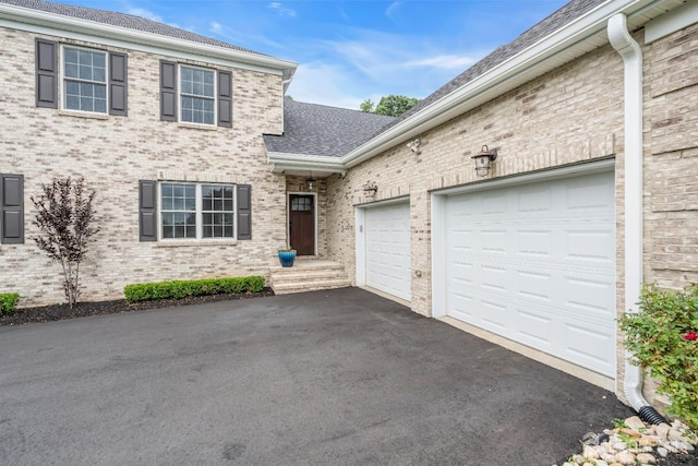 3 Malibu Ct, Jackson, NJ 08527 - view of front of property featuring asphalt driveway, brick siding, a garage, and roof with shingles