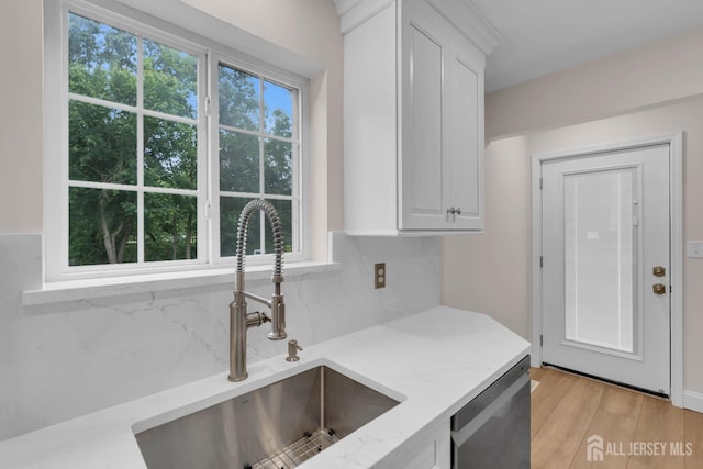 3 Malibu Ct, Jackson, NJ 08527 - kitchen featuring stainless steel dishwasher, backsplash, white cabinets, light stone countertops, and light wood-type flooring