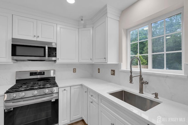 3 Malibu Ct, Jackson, NJ 08527 - kitchen with appliances with stainless steel finishes, white cabinetry, and decorative backsplash