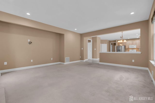 3 Malibu Ct, Jackson, NJ 08527 - unfurnished living room with light carpet, recessed lighting, and a chandelier