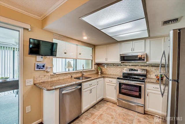 106-B Hemlock Plz, Monroe, NJ 08831 - kitchen featuring stainless steel appliances, tasteful backsplash, white cabinetry, ornamental molding, and light stone countertops