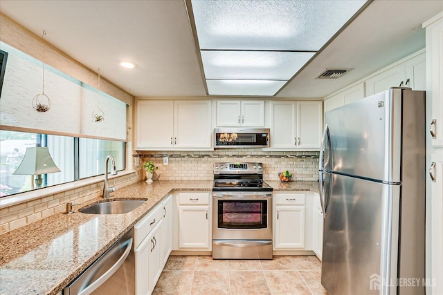 106-B Hemlock Plz, Monroe, NJ 08831 - kitchen with stainless steel appliances, tasteful backsplash, and white cabinets