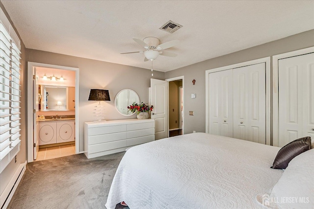 106-B Hemlock Plz, Monroe, NJ 08831 - carpeted bedroom featuring a baseboard heating unit, two closets, connected bathroom, and ceiling fan