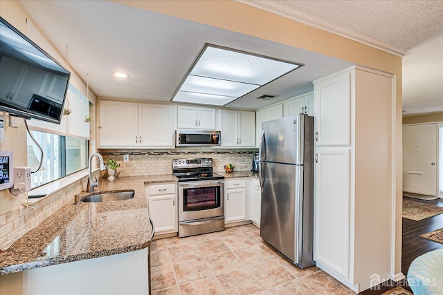 106-B Hemlock Plz, Monroe, NJ 08831 - kitchen featuring stainless steel appliances, light stone counters, tasteful backsplash, white cabinetry, and ornamental molding
