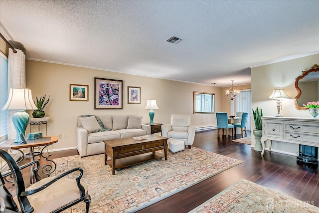 106-B Hemlock Plz, Monroe, NJ 08831 - living room featuring a chandelier, wood-type flooring, a textured ceiling, ornamental molding, and a baseboard radiator