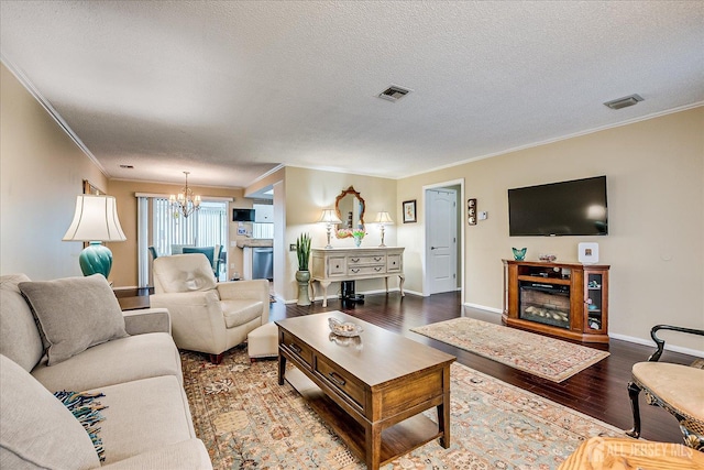 106-B Hemlock Plz, Monroe, NJ 08831 - living room with a chandelier, crown molding, wood finished floors, and a textured ceiling