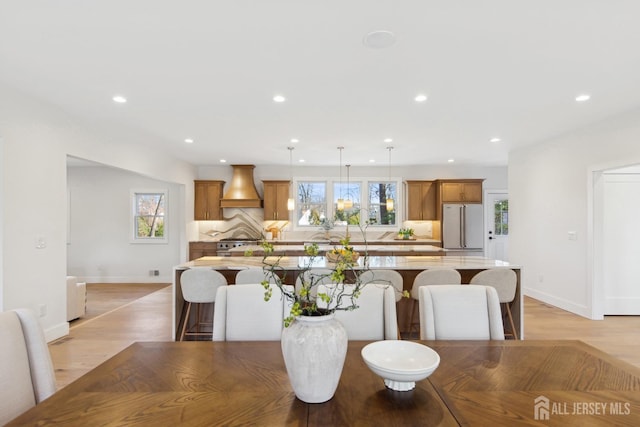 dining space with light hardwood / wood-style flooring