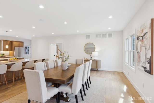 dining space featuring light wood-type flooring