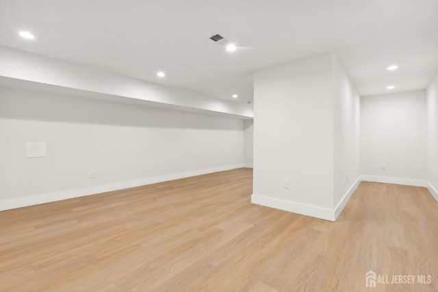 basement with light hardwood / wood-style flooring