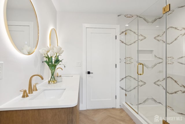 bathroom with vanity, parquet flooring, and a shower with shower door