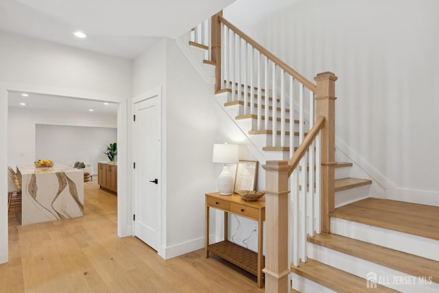 stairs with hardwood / wood-style flooring