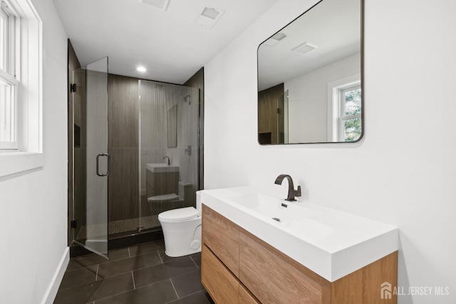 bathroom featuring an enclosed shower, vanity, tile patterned floors, and toilet