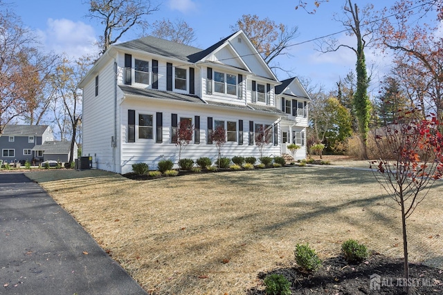 view of front of house featuring a front yard and central air condition unit