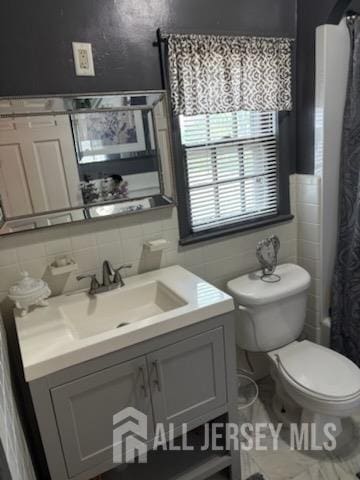 1472 Stanley Ter, Hillside, NJ 07205 - full bathroom with vanity, tile walls, a shower with shower curtain, and tasteful backsplash