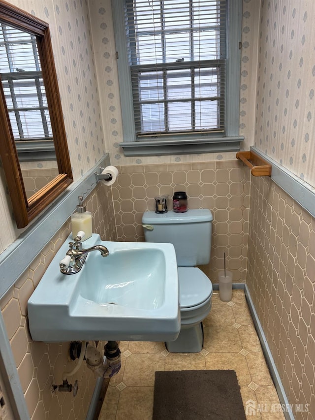1472 Stanley Ter, Hillside, NJ 07205 - half bathroom featuring wallpapered walls, wainscoting, and tile walls