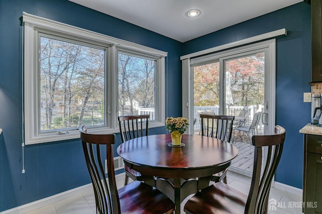 dining area featuring baseboards and light tile patterned flooring