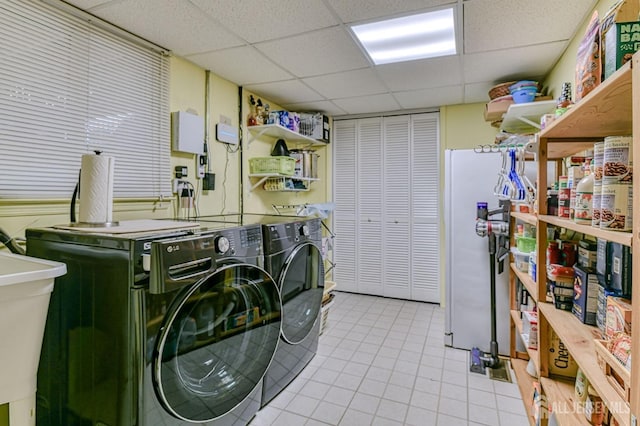 clothes washing area with laundry area, a sink, and washing machine and clothes dryer