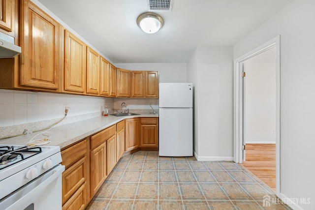 227 College Dr, Edison, NJ 08817 - kitchen with white appliances, light countertops, exhaust hood, and backsplash