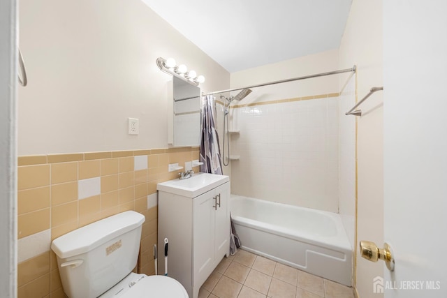 227 College Dr, Edison, NJ 08817 - bathroom featuring vanity, shower / tub combo, tile walls, tile patterned floors, and a wainscoted wall