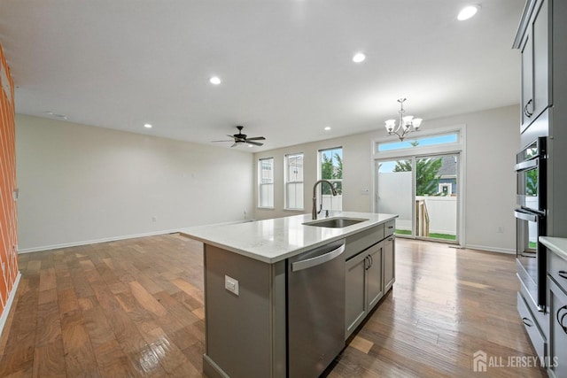 30 Clover Ln, Monroe, NJ 08831 - kitchen with appliances with stainless steel finishes, wood finished floors, a center island with sink, a ceiling fan, and recessed lighting