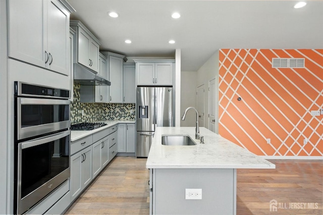 30 Clover Ln, Monroe, NJ 08831 - kitchen with appliances with stainless steel finishes, gray cabinets, under cabinet range hood, recessed lighting, and an island with sink