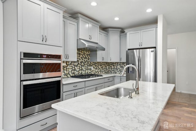 30 Clover Ln, Monroe, NJ 08831 - kitchen featuring appliances with stainless steel finishes, under cabinet range hood, gray cabinets, light stone countertops, and recessed lighting