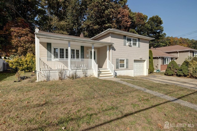 split level home with a garage, a front yard, and a porch