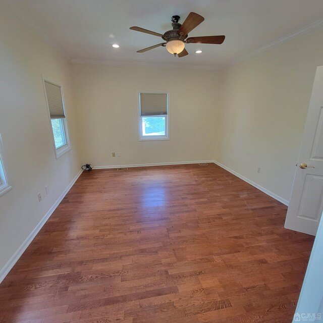 spare room with hardwood / wood-style floors, crown molding, and ceiling fan