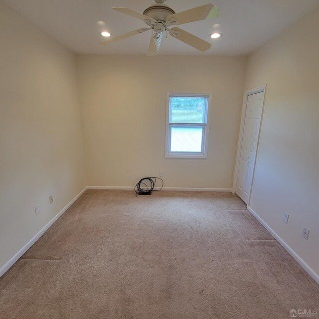 carpeted empty room with ceiling fan